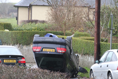 A black Saab turned on it roof on the Strangford Road just outside Ardglass.