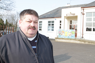 Rowallene Councillor Billy Walker, pictured outside Killyleagh Primary School where 26 windows were smashed, has condemned the recent outbreak of vandalism in Killyeagh.
