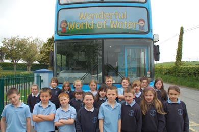 Pupils from St PAtrick's PS Legamaddy beside the NI Water waterbus. 