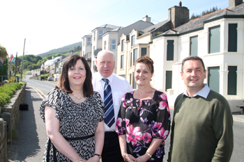 Margaret Quinn, Down District Council Project Development Officer with Newcastle Councillors Dessie Patterson, Carmel O'Boyle and Willie Clarke in front of seafront properties that were tidied up with the Dereliction Fund