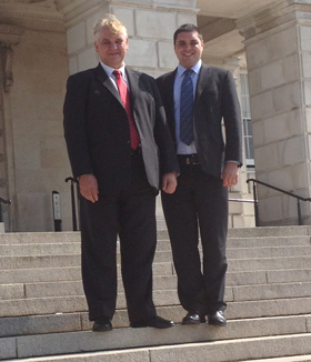 Councillor Henry Reilly and representative Alan Lewis on the steps of Stormont. 