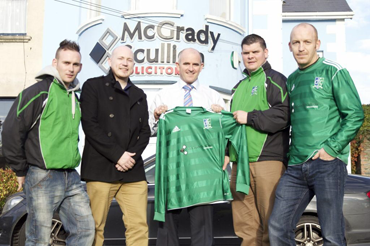Declan Green & partner Brian Scullion from McGradyScullion Solicitors Downpatrick present Downpatrick FC manager Ryan Doyle and players Shane Matheson and Paul Brady with a new strip.