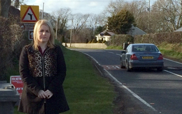 Sinn Féin local election candidate Naomi Bailie pictured at the Ballydugan Road, where re-surfacing is due to take place.
