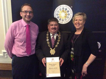Down District Council's Ellen Brennan (PCSP Officer) and Phillip Preen (Assistant Director, Corporate Services (Human Resources)) pictured with Council Chairman, Cllr Billy Walker after receiving the 'Safe Employer' bronze award at the recent Onus Awards Ceremony in Belfast City Hall. 