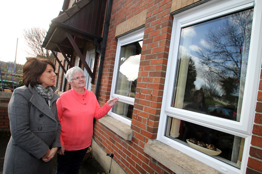 NIHE official Bronagh Magorrian pictured with Cumber Hill resident Mrs Phyllis Toman in Drumaness as she looks over her new PVC double glazing.