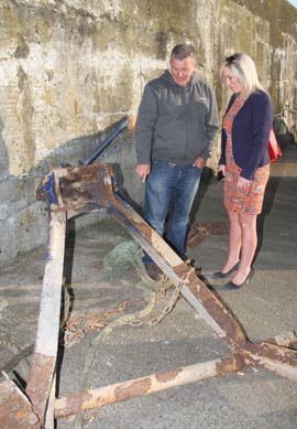 Karen skipper Paul Murphy looks over the heavy steel supports ripped off the deck when a submarine snagged his nets. Looking on is Fisheries Minister Michelle O'Neil at Ardglass harbour. 