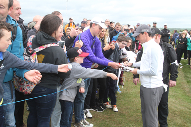 Rory McIlroy signs autographs for his many fans. 