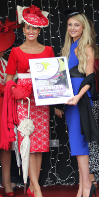 Last year’s winner of the Most Appropriately Dressed Lady competition at Downpatrick racecourse – Nicole Caldwell - left, receives her prize from former Miss Northern Ireland, Megan Green.