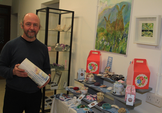 NIck Mack shows off a selection of the local craft goods on sale at Bayview Synergie Studio at 101 Main Street in Newcastle.