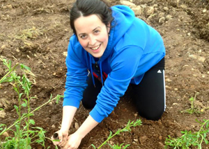 A volunteer enjoys planting out wildflowers last year.