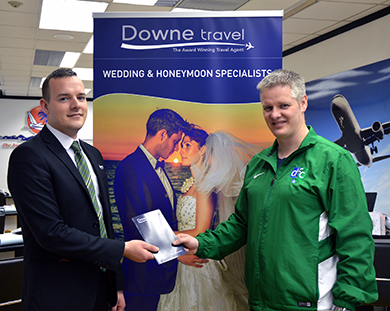 Stephen Mullan of Downe Travel, who sponsored the match against Carryduff with Downpatrick FC official Tony McShane.
