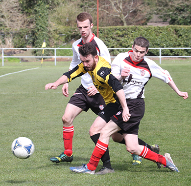Comber’s David Smyth in a tangle with the Killyleagh defenders.