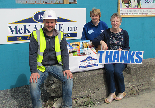 Michael Kane, Site Manager for P&K McKaigue Ltd, with Shirley Lennon and Rosemary Wilson, Foodbank volunteers.