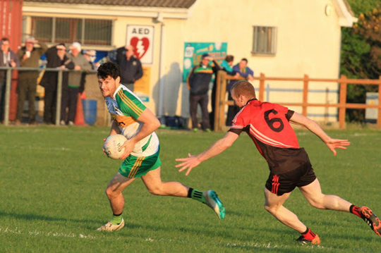 An Roichts Martin Clarke attacks the Rostrevor goal.