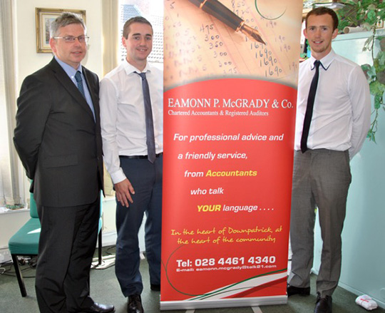 Michael Rowan, Manager of Eamon P McGrady's in Downpatrick, with , Stephen Galbraith, Downpatrick player, and Gary Murdock, a Drumaness player, who both are employees at McGrady's.