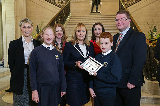 Back (l-r) Dr Judith Harper, Principal, Derryboy Primary School, Suzanne Harrison, Northern Ireland Screen, Aisling Gallagher, Producer, Morrow Communications and Ian Crozier, CEO, Ulster-Scots Agency. (Front l-r) Grace Elwood, Minister of Agriculture, Environment and Rural Affairs, Michelle McIlveen MLA, and Reuben Maitland.