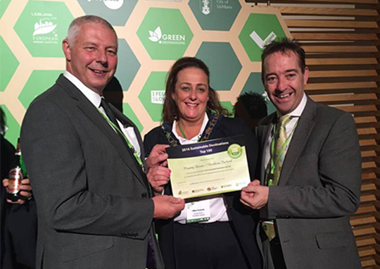 Newry, Mourne and Down District Council Chairperson, Councillor Gillian Fitzpatrick accepts the Top 100 Sustainable Destination 2016 Award on behalf of County Down, alongside Robert Burgess, Chairman of Enterprise Regeneration and Tourism Committee and Mark Mohan, Newry, Mourne and Down District Council Senior Tourism Initiatives Manager.